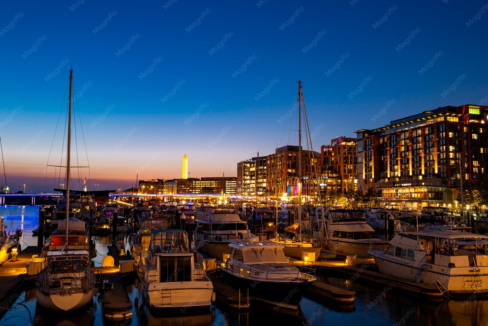 Washington, DC waterfront marina with boats and city lights at dusk