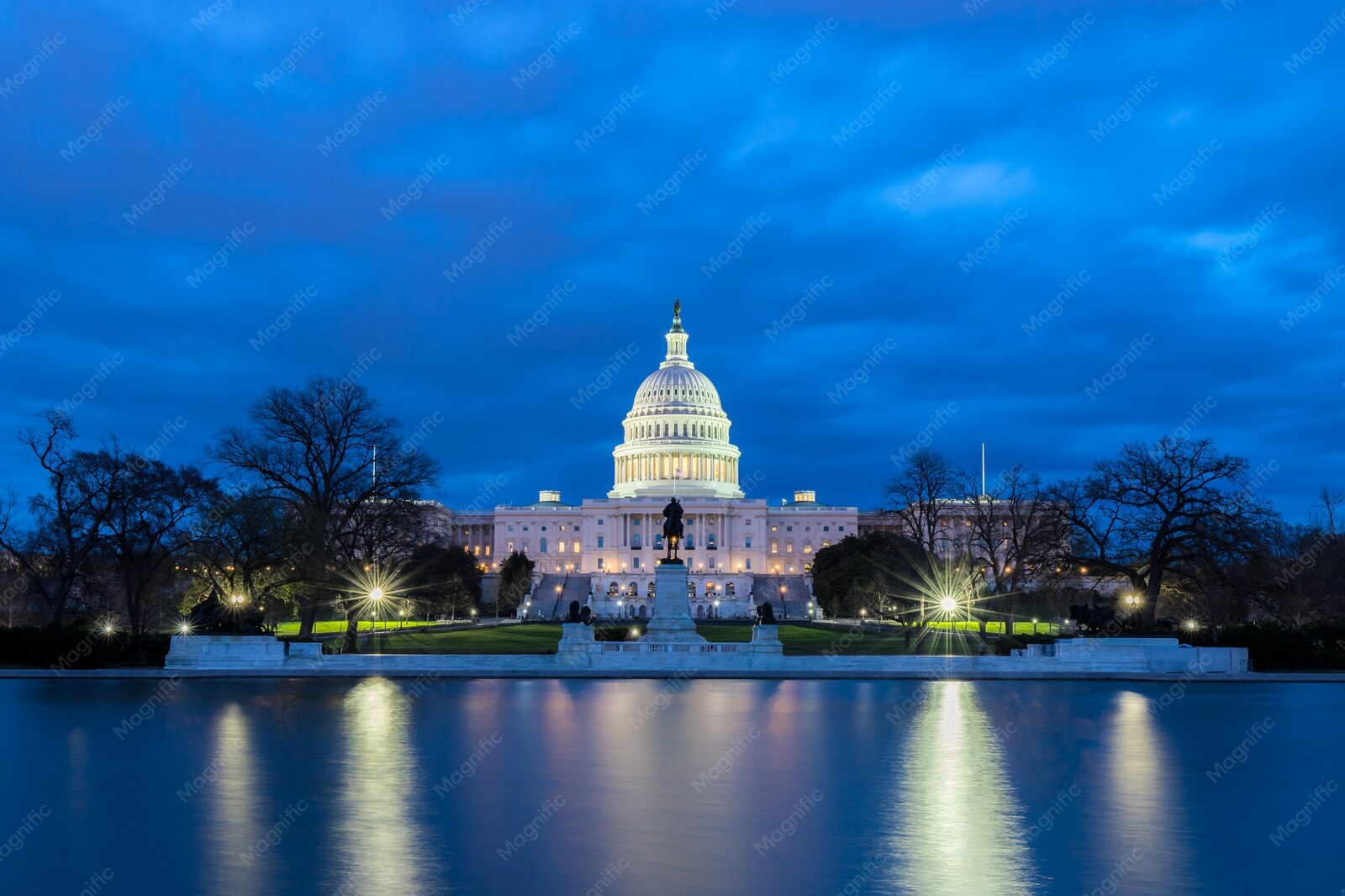US Capitol dome lit at night and reflected in the water in Washington, DC